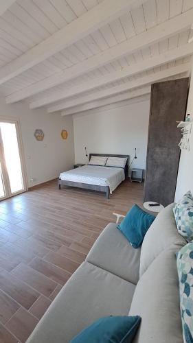 ein Wohnzimmer mit Sofa und Bett in der Unterkunft CasaAmena in Nardò