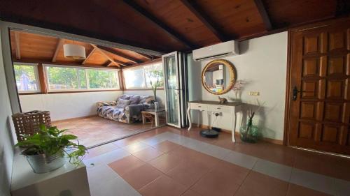 a living room with a couch and a mirror at Casa Domi in Valle Gran Rey