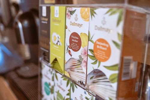 three boxes of orange cookies are stacked on a counter at Hotel Bachschmied in Maria Alm am Steinernen Meer