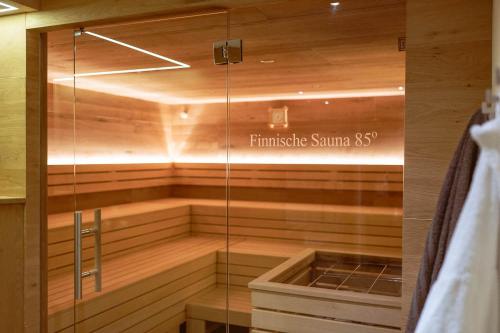 a sauna with a glass box in a room at Hotel Bachschmied in Maria Alm am Steinernen Meer