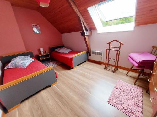a bedroom with two beds and a window at Lusachères in La Pellerine