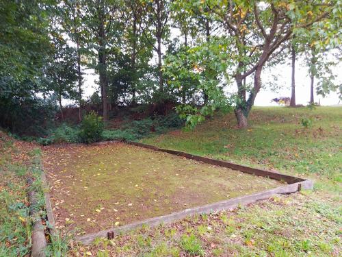a raised garden in a field with trees at Lusachères in La Pellerine