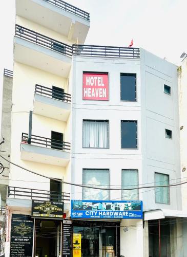 a white building with a hotel heaven sign on it at Hotel Heaven in Rohtak