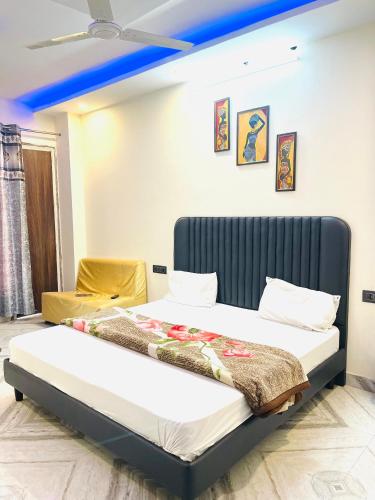 a bedroom with a bed with a blue ceiling at Hotel Heaven in Rohtak