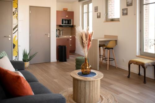 ein Wohnzimmer mit Sofa und Tisch in der Unterkunft Studio Lucien - Villa Bon Accueil proche mer in Mers-les-Bains