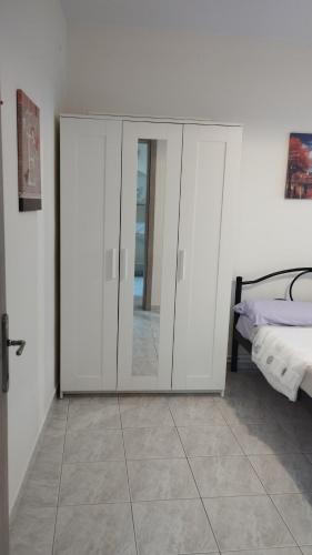 a bedroom with a sliding glass door next to a bed at Maraki's house in Kavala