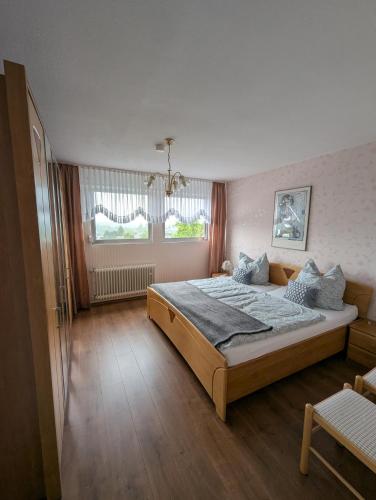 a bedroom with a large bed and a window at Eifel-FeWo by Eva Kröll in Manderscheid