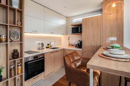 a kitchen with wooden cabinets and a wooden table with a counter at Brand New Luxury Apartments with Great Views in Sofia