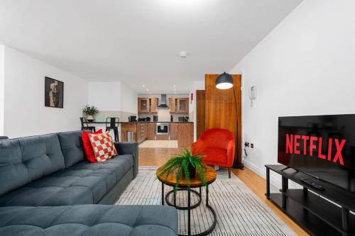a living room with a couch and a table at 2 Bed Altrincham Flat Free Parking in Altrincham