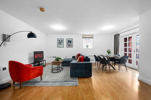 a living room with a couch and a table at 2 Bed Altrincham Flat Free Parking in Altrincham