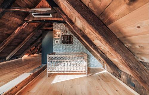 an attic with a bench in the middle of it at 3 Bedroom Nice Home In Derezani 
