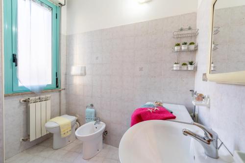 a white bathroom with a sink and a toilet at Ippocampo New 2 in Silvi Paese