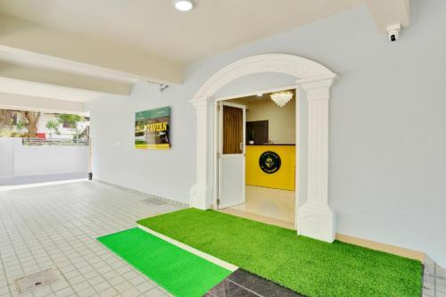 a room with a green rug on the floor at Super Collection O Lefort LUXE by PopTavern in Trivandrum