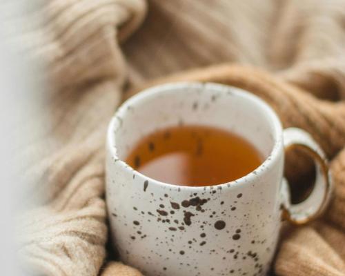 a cup of tea sitting on top of a blanket at Alpenrose in Obermaiselstein