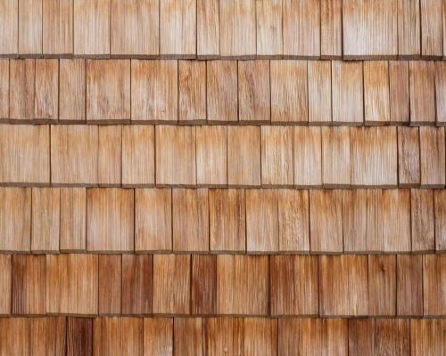 a close up of a wooden wall with brown tiles at Alpenrose in Obermaiselstein