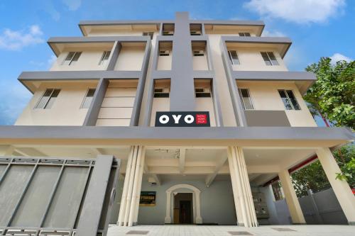 a building with a sign on the front of it at Super Collection O Lefort LUXE by PopTavern in Trivandrum