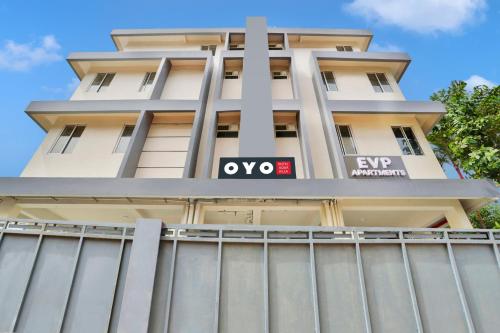 an apartment building with a sign on it at Super Collection O Lefort LUXE by PopTavern in Trivandrum