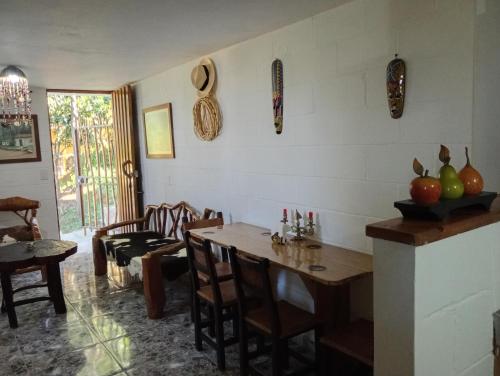 a living room with a table and chairs and a room with a table at Apartamento Campestre Medellin in Medellín