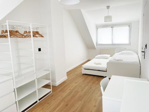 a white room with a bed and bunk beds at L'Orangerie, Maison moderne avec jardin in Berck-sur-Mer