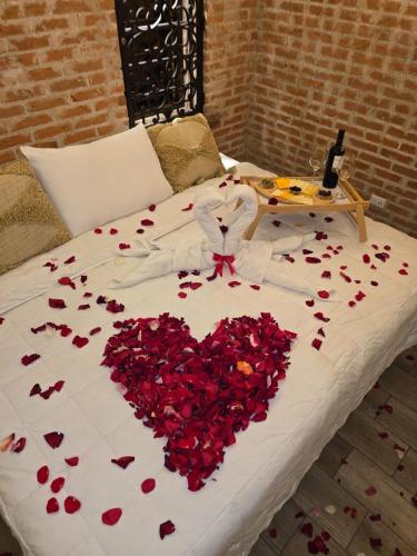 a bed with a heart made out of red roses at Hot Chipilin in Antigua Guatemala
