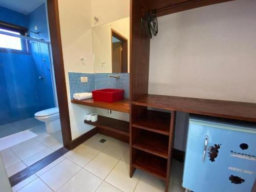a bathroom with a sink and a toilet and a mirror at Thai Pousada - Itamambuca in Ubatuba