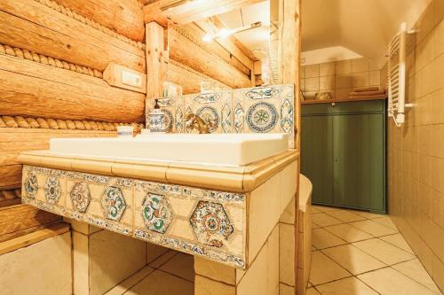 a bathroom with a sink in a wooden house at Chatka Koniaków 7 in Koniaków