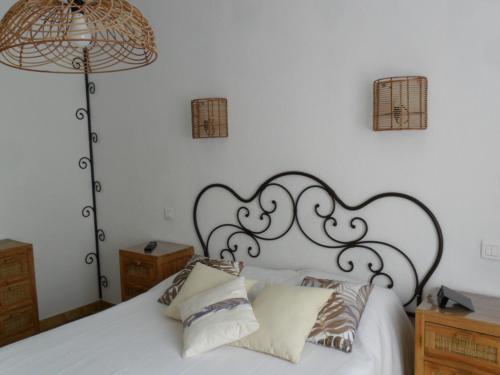 - une chambre avec un lit blanc et une tête de lit noire dans l'établissement Villa la Câline, à Maillane