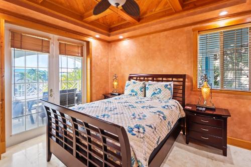 a bedroom with a bed and a ceiling fan at Fishermans Paradise in Marathon