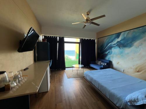 a bedroom with a bed and a ceiling fan at Beachfront Hotel, La Mercy in Umhlanga