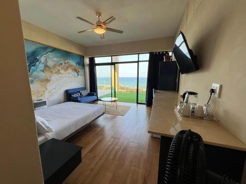 a bedroom with a bed and a ceiling fan at Beachfront Hotel, La Mercy in Umhlanga