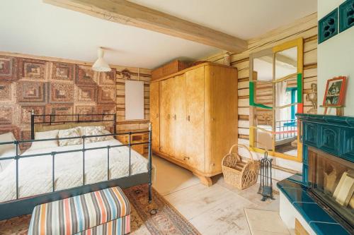 a bedroom with a bed and a wooden wall at Chatka Koniaków 7 in Koniaków