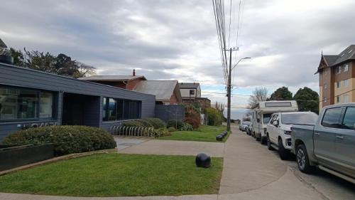 a house with cars parked on the side of a street at HOM I Con parking incluido Depto 1D1B in Puerto Varas