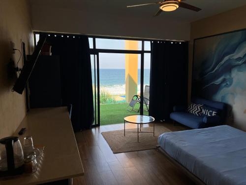 a bedroom with a bed and a view of the ocean at Beachfront Hotel, La Mercy in Umhlanga