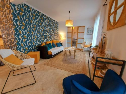 a living room with a couch and chairs at La Maison Bleue in Saint-Vincent