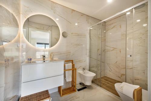 a bathroom with a sink and a shower at Sunny Apartments in Cabanas de Tavira