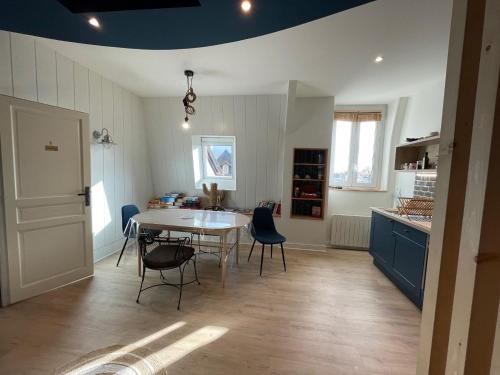 a kitchen with a table and chairs in a room at Maunoury Citybreak in Chartres