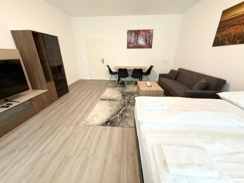 a living room with a couch and a table at Domloge Lofts & Apartments in Cologne
