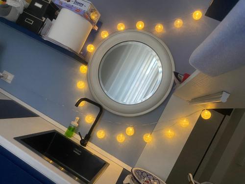 a bathroom with a mirror and lights on the counter at San Nicolicchio al Borgo in Taranto