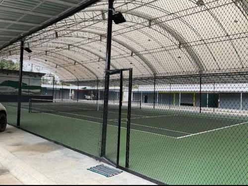 a tennis court with two tennis courts at Sleepymoon Hostel in Thongsala