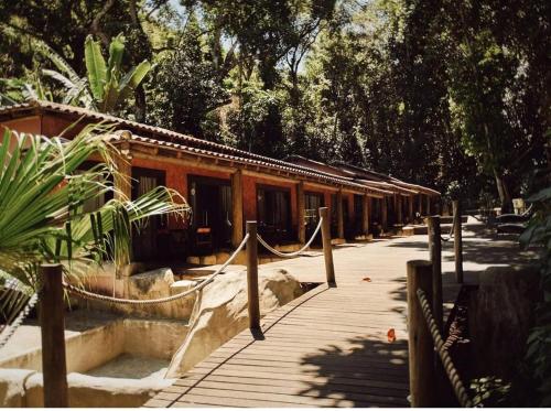 a building with a wooden walkway in front of it at Praia da Crena in Abraão
