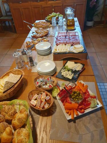 a table topped with lots of different types of food at Hotelový a jezdecký areál Dvůr Krutěnice in Krutěnice