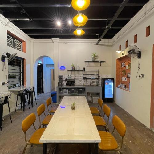 a large room with a table and chairs at Miner's House Ipoh in Ipoh