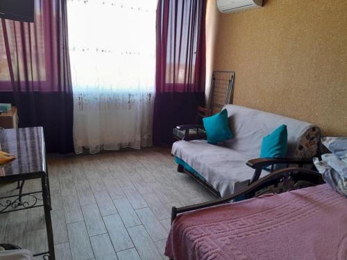 a living room with a couch and a window at Zatoka in Zatoka