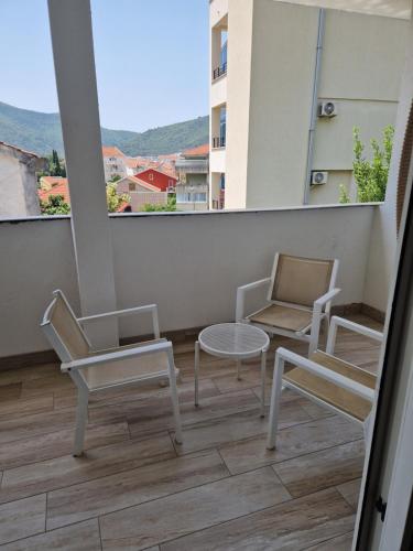 a balcony with two chairs and a table and chairs at Villa Golf 2 in Budva