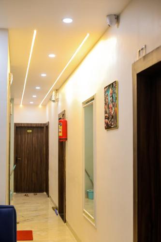 a hallway of a hospital with a door and a fire hydrant at Hotel shiv ganga in Ujjain
