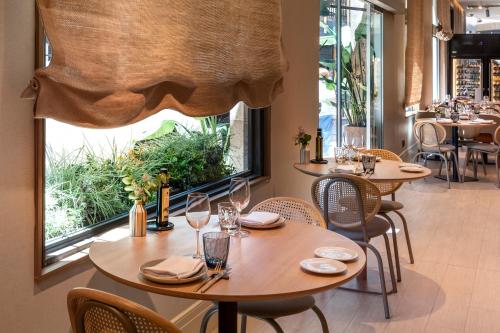a restaurant with tables and chairs and a large window at Catalonia Excelsior in Valencia