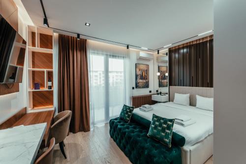 a hotel room with a bed and a couch at BW Symphony Suites in Belgrade