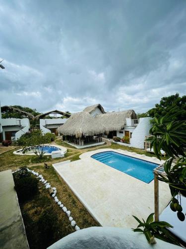 a resort with a swimming pool and a building at Casa Dibulla Hotel Boutique in Dibulla