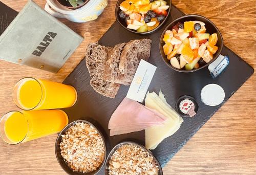 a table topped with bowls of food and snacks at São Miguel Apartments in Porto
