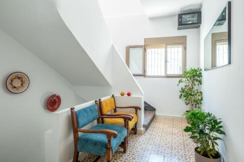 a hallway with two chairs and a stair case at Studio JOSAFAT Medina Tanger in Tangier
